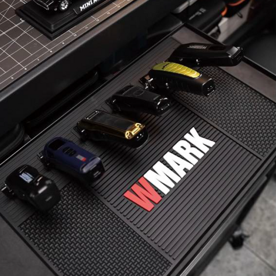 WMARK W-41 magnetic barber mat holding six clippers on professional workstation with visible branding